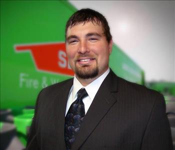 man in suit with a SERVPRO trailer backdrop